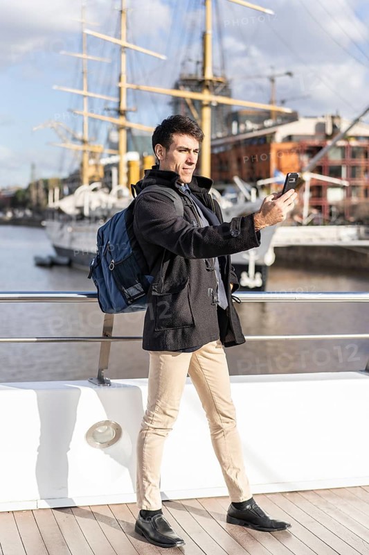 Handsome tourist taking selfies in Puerto Madero