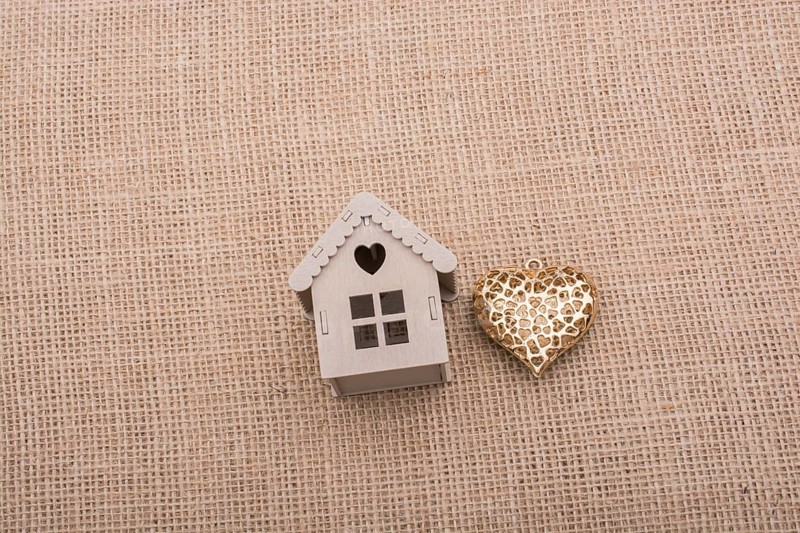 Heart shaped icon and model houses on a brown background