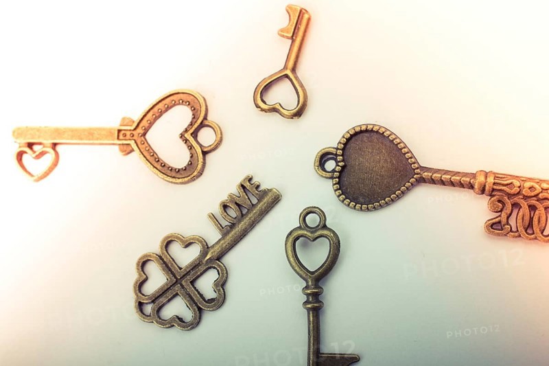 Heart shaped retro metal keys on white background