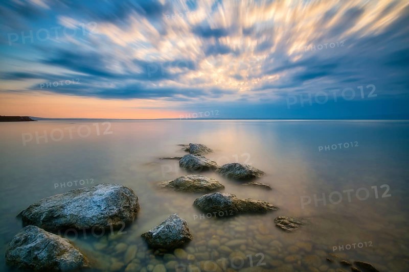 Atmospheric clouds at sunrise on Lake Constance