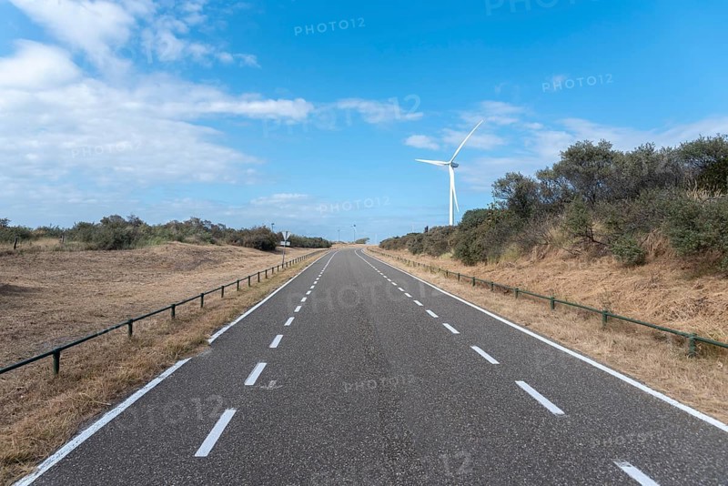 Access road to Banjaard beach with wind turbines of the Oosterschelde Barrage