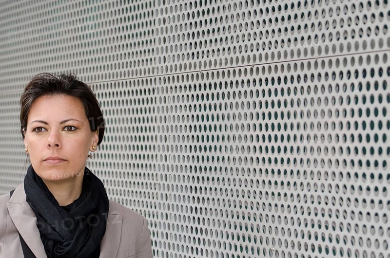 Headshot on a Self Confident Woman on Modern Design Wall