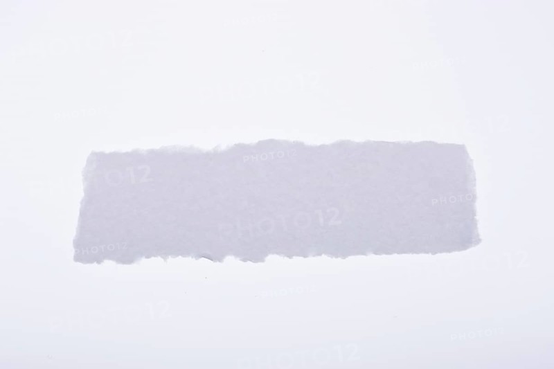 A piece of white blank torn note paper
