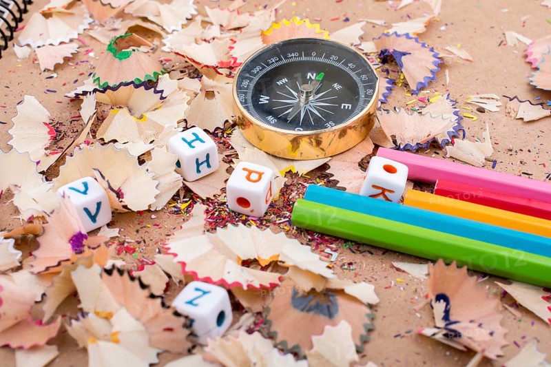 The compass instrument and a few colorful pencils