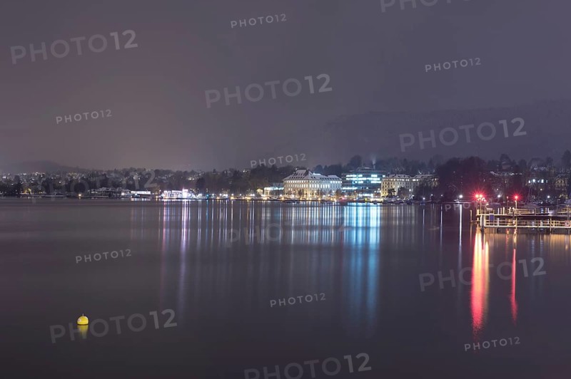 Cityscape at Night with Lake Zurich and Mountain in Switzerland