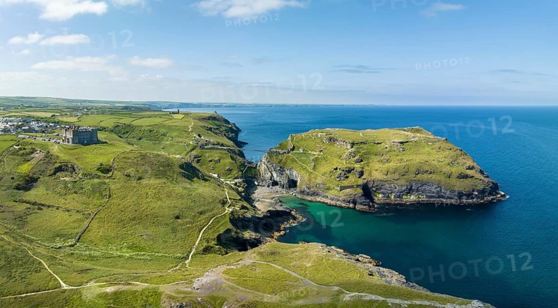 Aerial panorama of the rugged coastline on the Celtic Sea with the Tintagel Peninsula and the ruins of Tintagel Castle