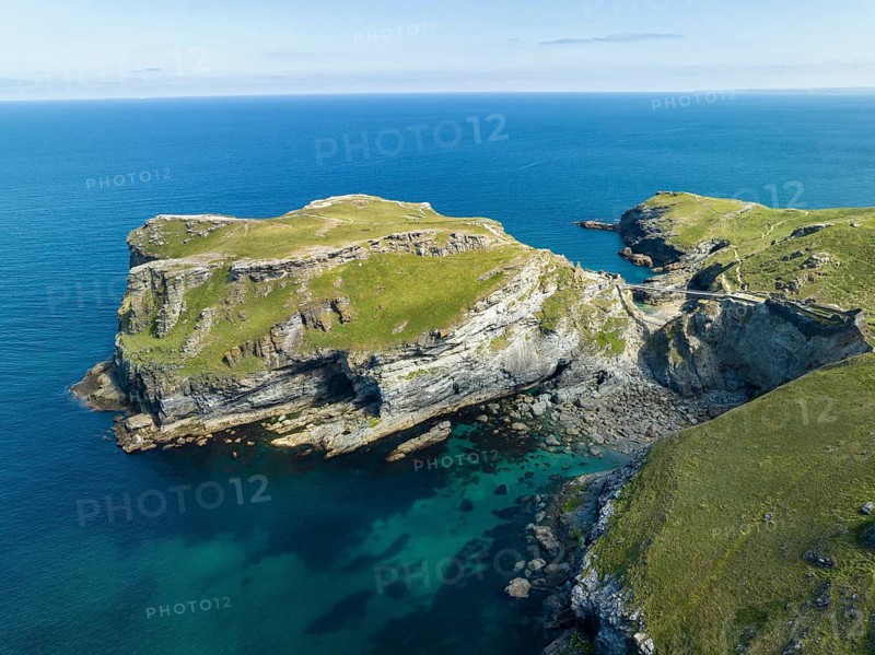 Aerial view of the rugged coastline on the Celtic Sea with the Tintagel Peninsula and the ruins of Tintagel Castle