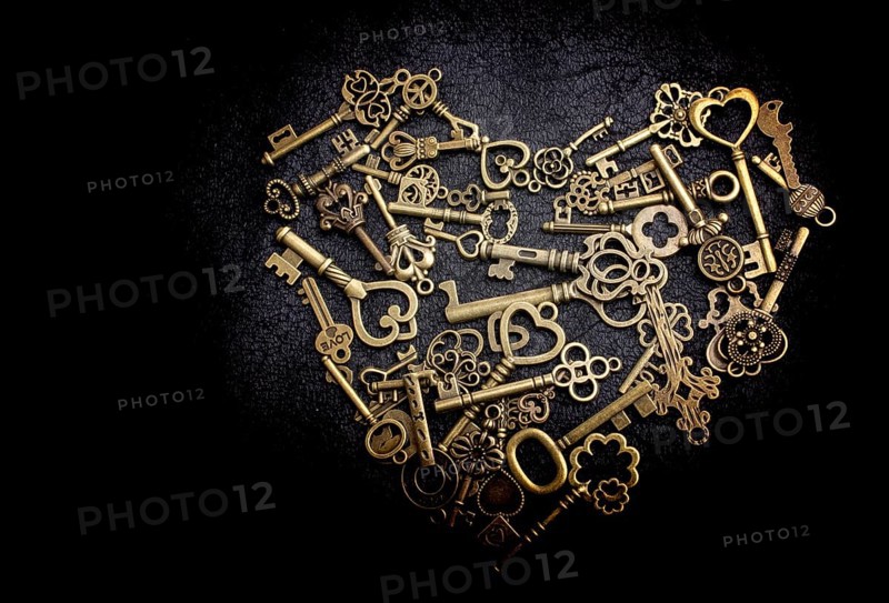 Retro metal keys form a heart shape on black