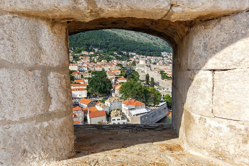 View of the old town through an opening in the wall of the fortress in Dubrovnik