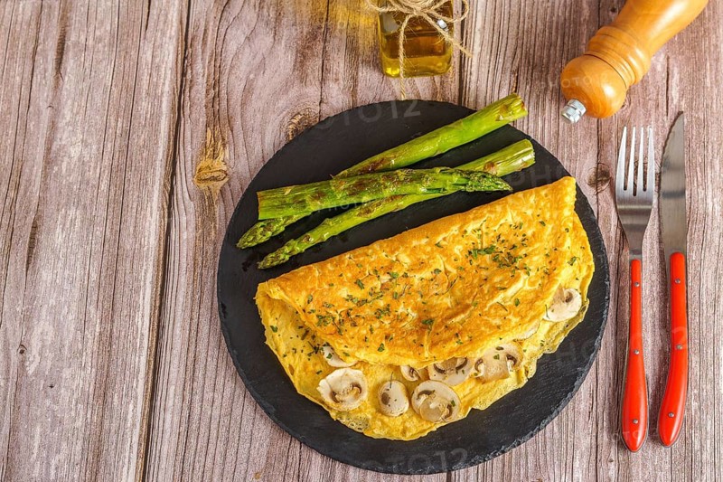 Mushroom omelette with wild asparagus on a slate