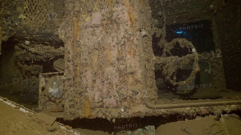 Close-up of truck cab lying on its side inside hold of ferry Salem Express shipwreck