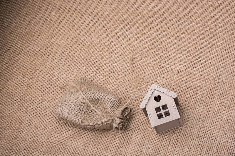Model house beside a sack on a canvas background