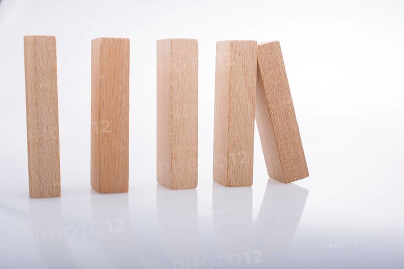 Wooden Domino Blocks in a line on a white background