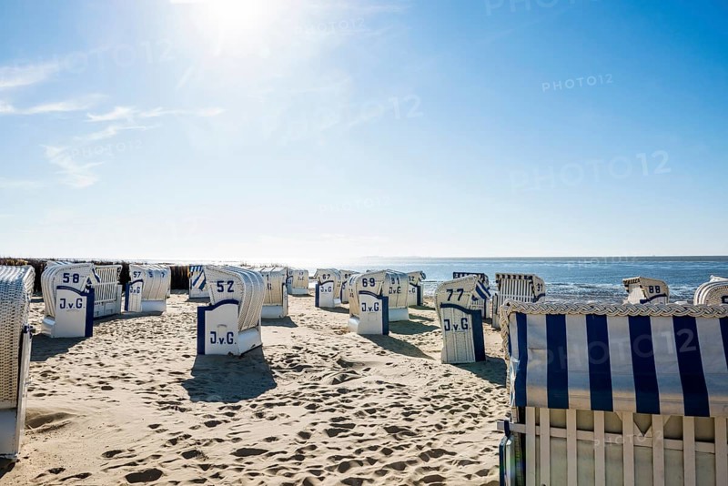 White beach chairs and mudflats