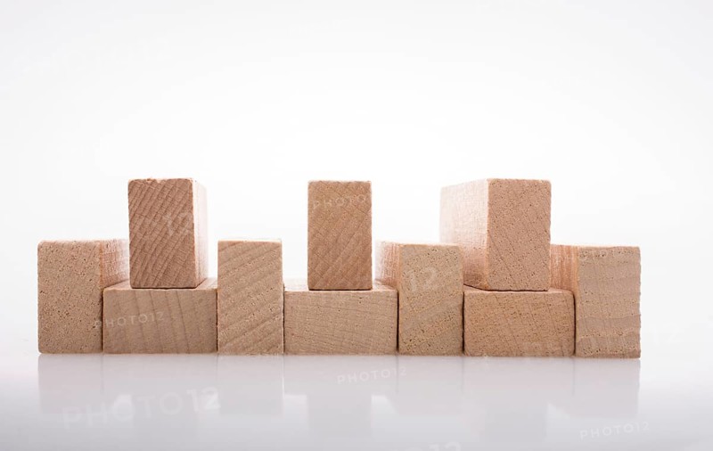 Wooden Domino Blocks in a line on a white background