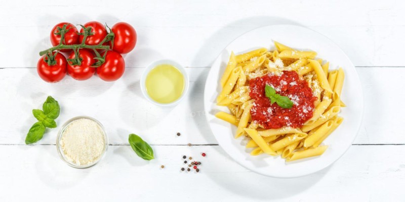 Penne Rigatoni Rigate Italian pasta in tomato sauce eat lunch dish on plate from above Panorama in Stuttgart