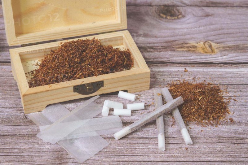 Wooden box with rolling tobacco