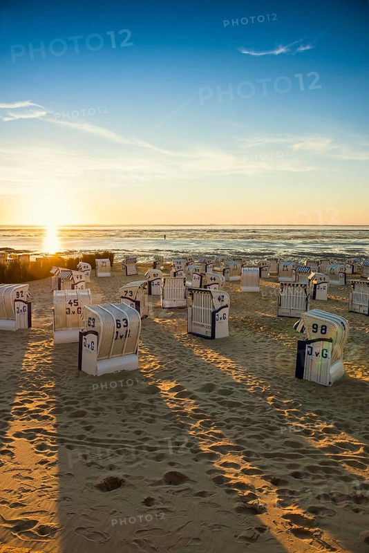 White beach chairs and mudflats