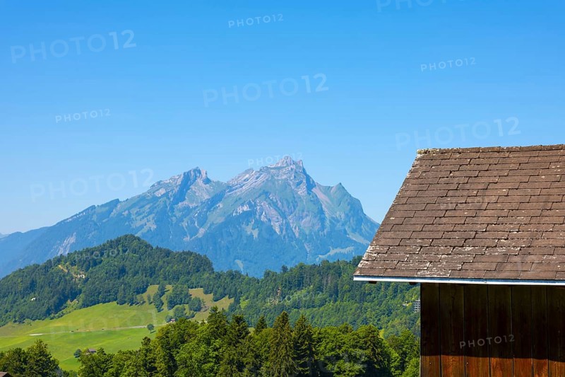 Rooftop and Mountain Peak Pilatus with Clear Blue Sky in Burgenstock