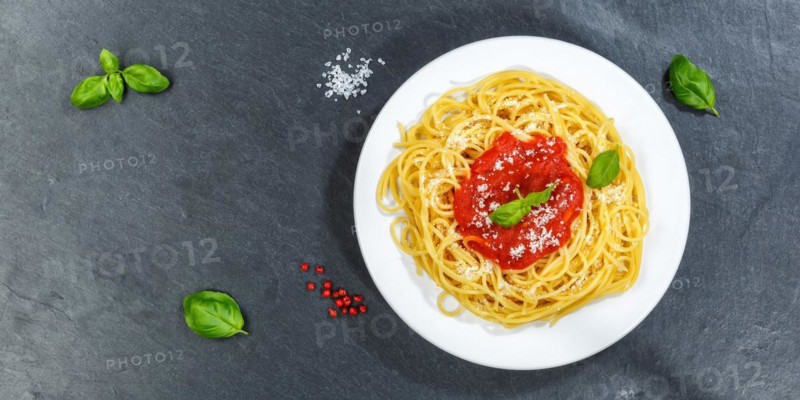 Spaghetti eating Italian pasta lunch dish with tomato sauce from above panorama on slate in Stuttgart