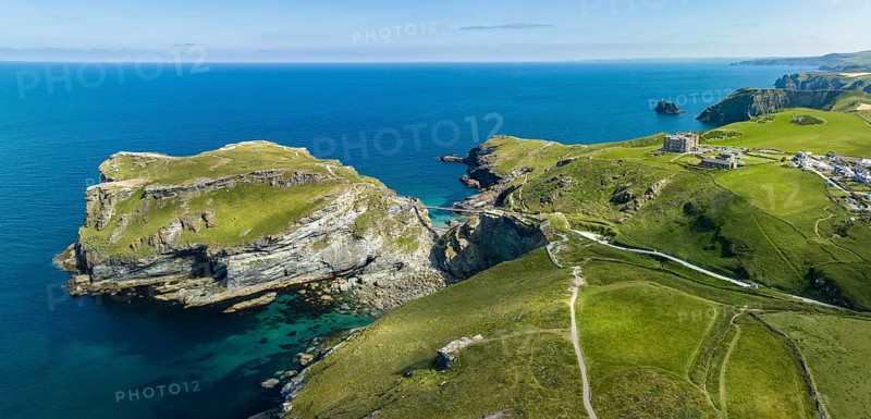 Aerial panorama of the rugged coastline on the Celtic Sea with the Tintagel Peninsula and the ruins of Tintagel Castle