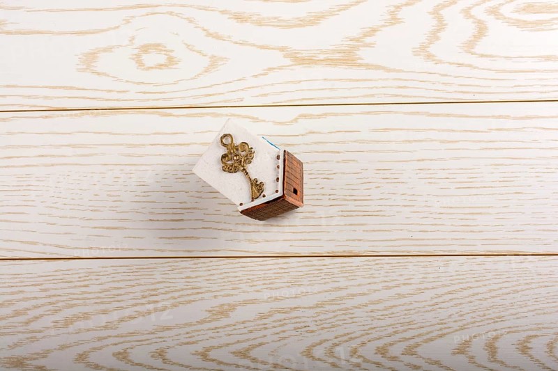 Model house and key and on parquet background