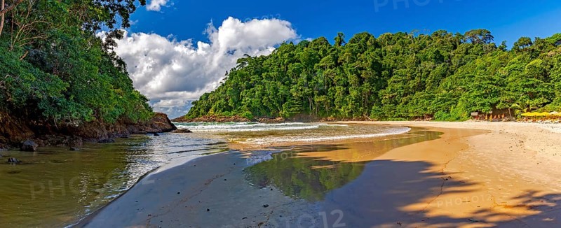 Panoramic image of Ribeira beach surrounded by rainforest and with the river flowing into the sea in Itacare on the south coast of Bahia