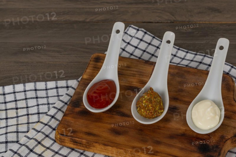Spoons three sauces ketchup mayonnaise mustard