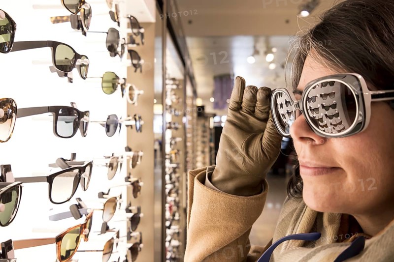 Woman Trying Sunglasses in Shop