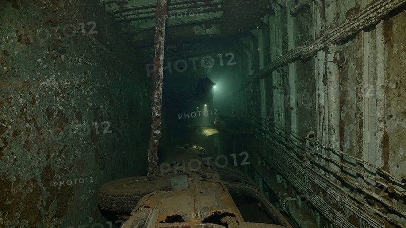 Scuba diver swim above car lying inside cramped hold of ferry Salem Express shipwreck