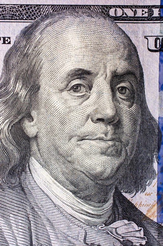 Close up of Benjamin Franklin face on 100 US dollar bill