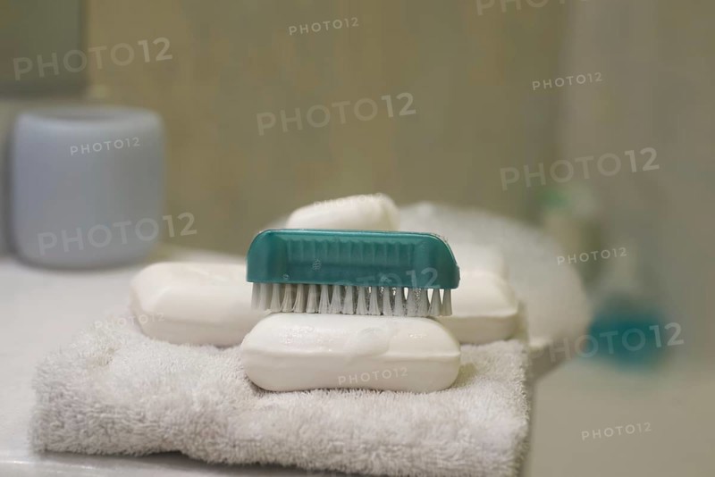 Soap and brush nail cleaner in bathroom