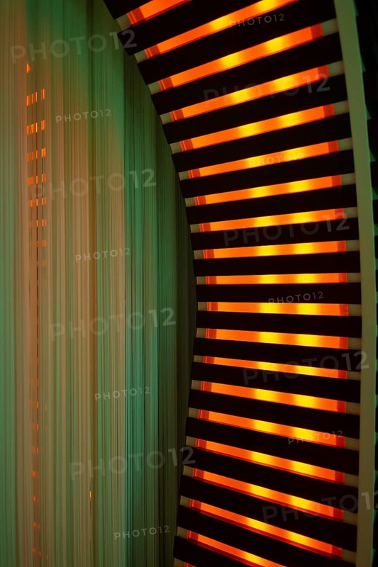 Illuminated Orange Stripes on a Modern Column in Switzerland