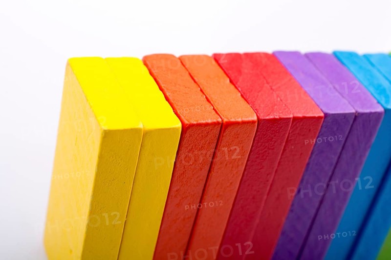 Colorful Domino Blocks in a line on a white background