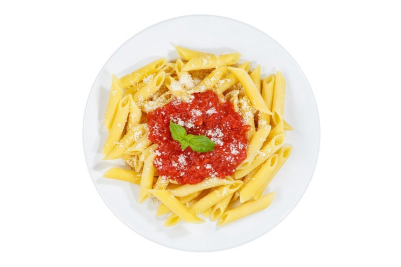 Penne Rigatoni Rigate Italian pasta in tomato sauce exempted isolated eat lunch dish on plate from above in Stuttgart