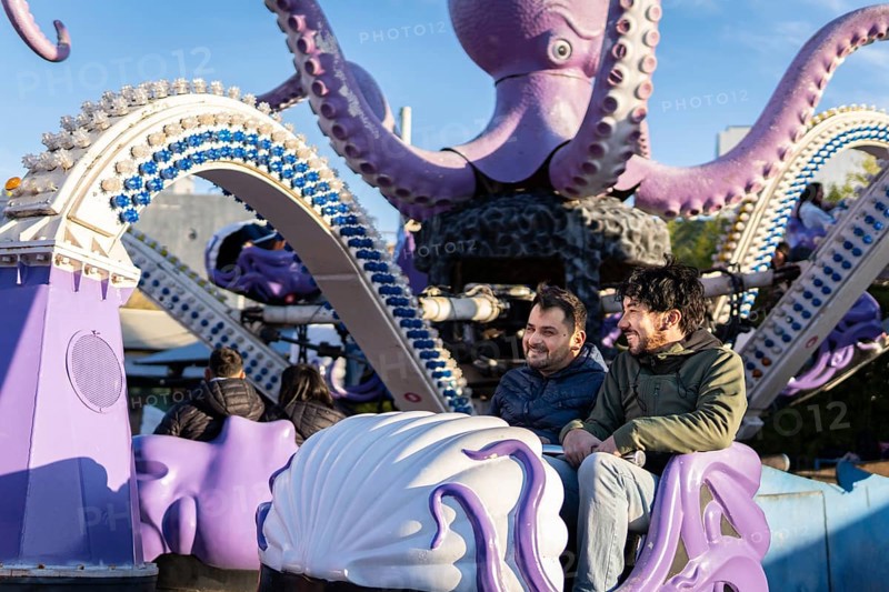 Couple of latin friends having fun in an amusement park