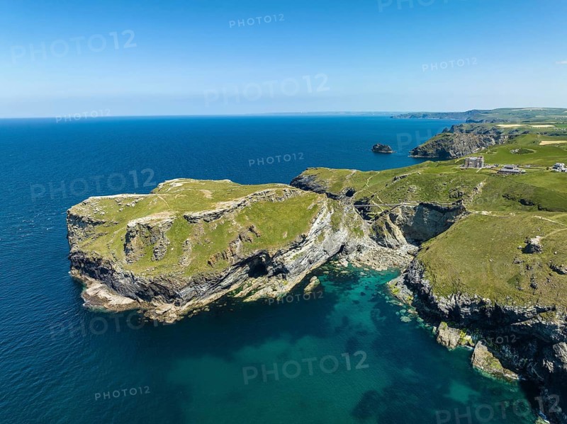 Aerial view of the rugged coastline on the Celtic Sea with the Tintagel Peninsula and the ruins of Tintagel Castle