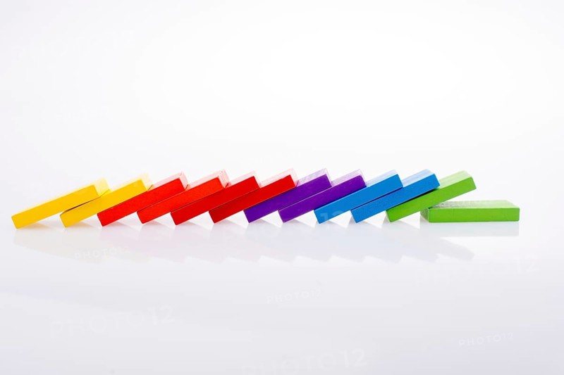 Colorful Domino Blocks in a line on a white background