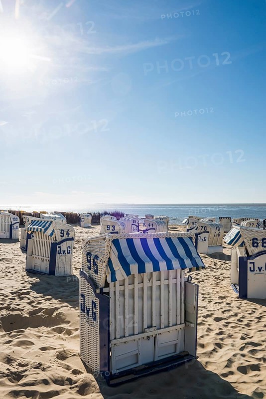 White beach chairs and mudflats
