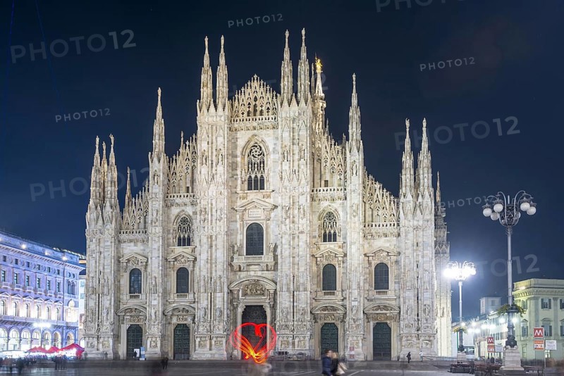 Person Light Painting a Heart Shape in Front of the Cathedral in City of Milan