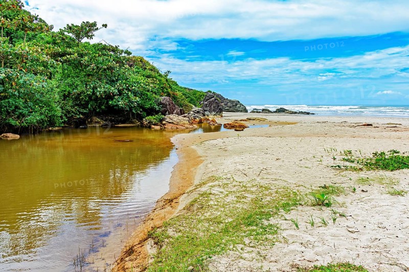 River going towards the sea with the sand