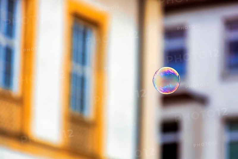 Single soap bubble floating in the city centre