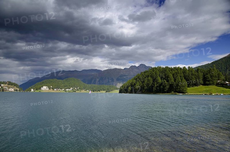 St Moritz Lake and Mountain and Green Trees with Grey Clouds in a Sunny Day in Switzerland