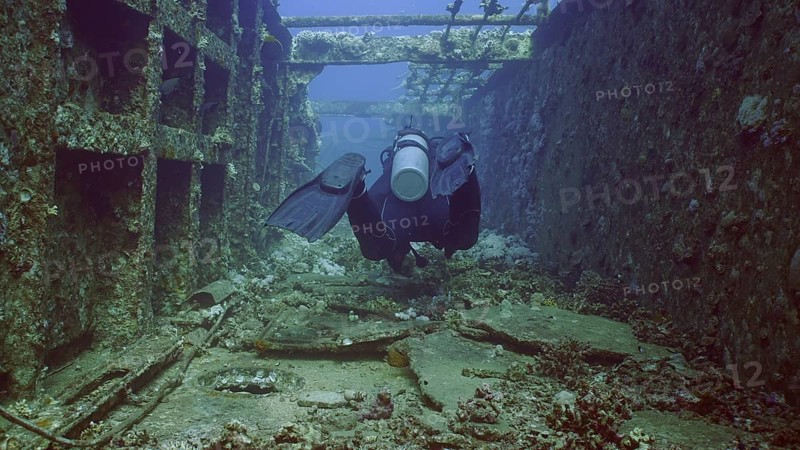 Scuba diver swim down corridor of ferry Salem Express shipwreck