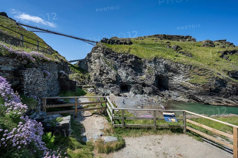 Viewing platforms on the cliffs of Tintagel with the old and new footbridge to the ruins of Tintagel Castle and the fabled Merlins Cave