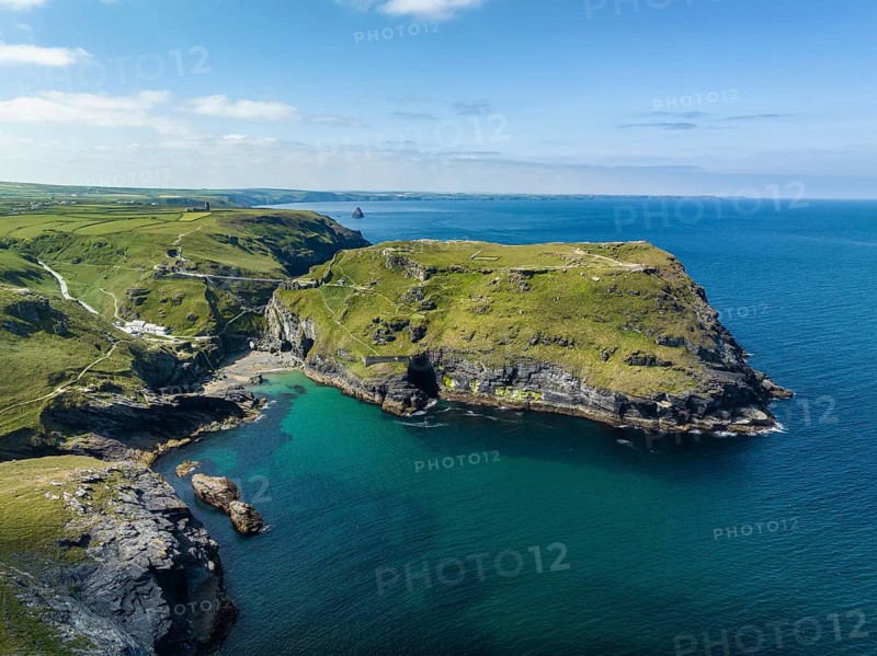 Aerial view of the rugged coastline on the Celtic Sea with the Tintagel Peninsula and the ruins of Tintagel Castle