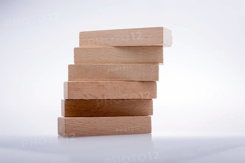 Wooden Domino Blocks in a line on a white background