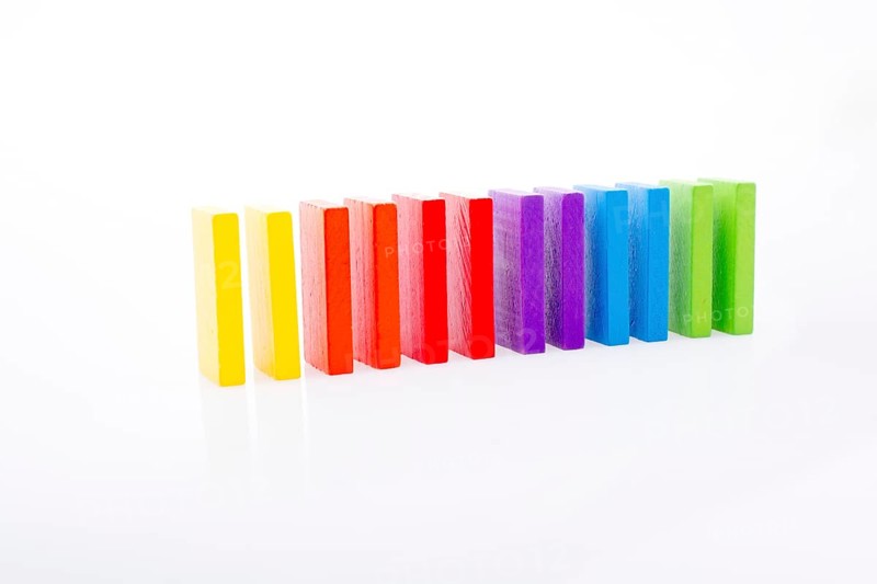 Colorful Domino Blocks in a line on a white background