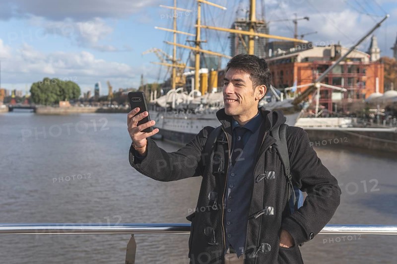 Happy tourist taking a selgie in Puerto Madero