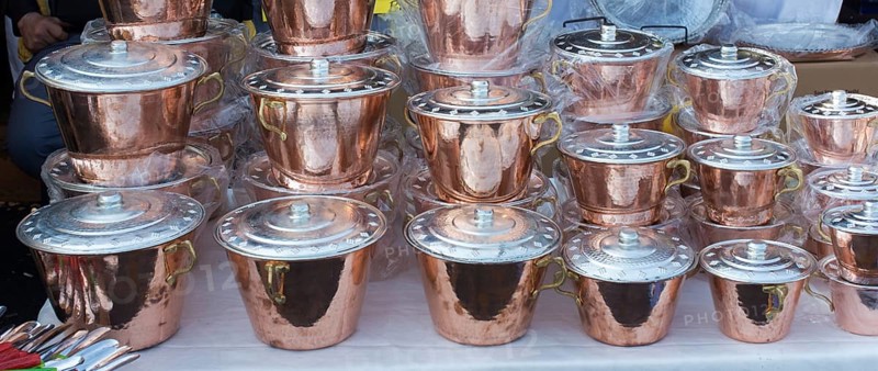 Little set of buckets of made of metal in a market place